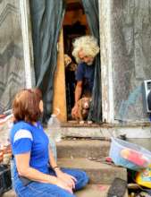A man was living on a front porch with his puppy.