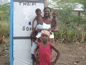 A family shows off their SOIL toilet