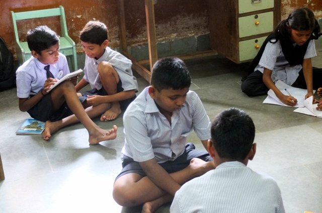 Children collaborate on a task