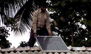 A solar panel being installed on the roof top
