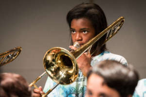 A trombone player plays with diligence!
