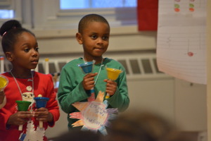 Students practice rhythms with hand bells.
