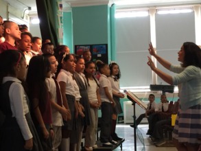 Students sing joyfully as their teacher conducts!