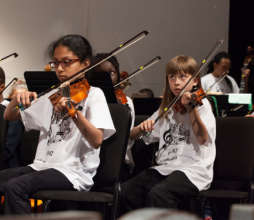 Orchestra students play with dedication!