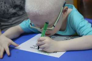 Hii is writing his name.