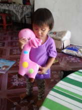 Maira embracing her favorite pink chou chou giraff