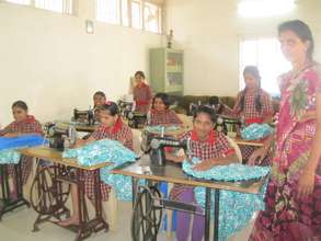 Tailoring class instructor helping them