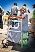 Elderly Woman resting on Stool in Cite du Soleil