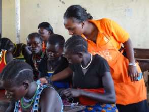 Samantha teaches girls to sew the DfG Kit
