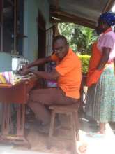 DfG Trainer Julius setting up the sewing machine