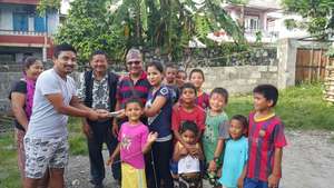 Community Liason, Lok, handing over the rent money