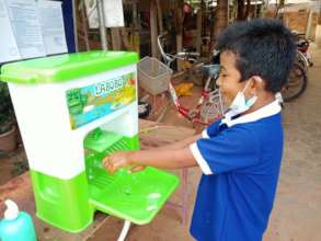 Children wash hands before they enter to class