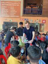 Giving a toothbrushing and toothpaste to students