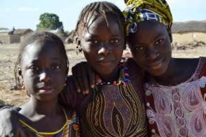 Three young girls smile in Neneko