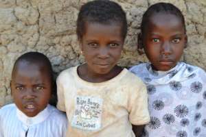 Village children take a break from school to pose