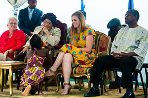 President Sirleaf listens at MTM Academy opening