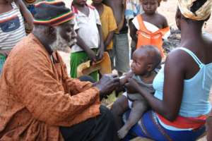 Health Agent Vaccinating a Child
