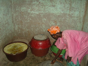 Village woman showing her processed shea butter.  It is now read