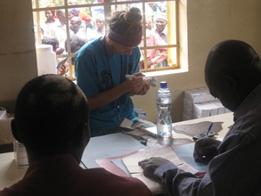 Volunteer documenting medication