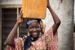 Helen carrying water to her home
