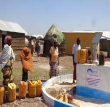 Community members line up for fresh water