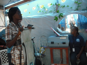 Dispensing water from a DayOne Waterbag in Haiti