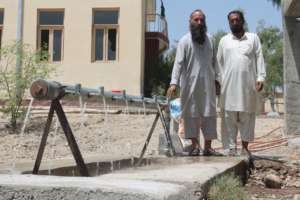 Officials pose with the new well