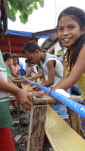 Children using a newly installed washing station