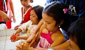 Children using the new hand washing station.