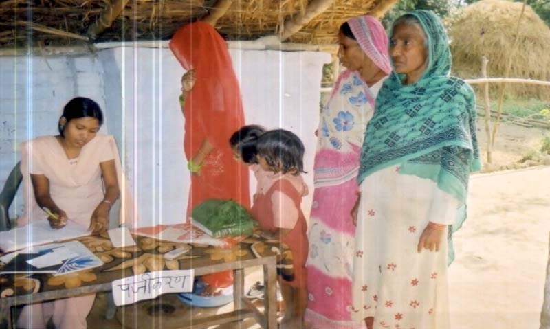 Children with their guardians collecting health manuals