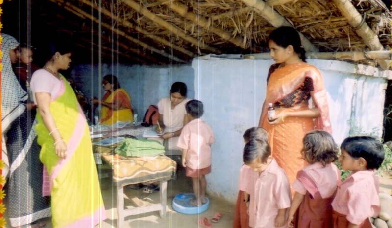 Children being weighed at a health camp