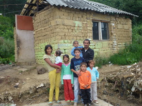 Emil and his family with their old house