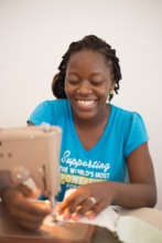 Ana Iris sewing an Upcycled bag.