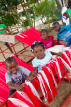 Guests play in hammocks made from recycled sails