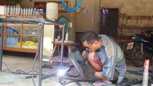 The local mechanic helping to weld the frames
