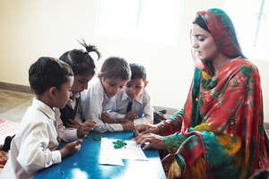 A DIL teacher works with her students