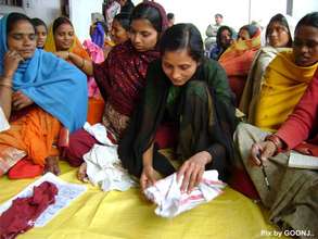 A lady trying to make the sanitary pad!