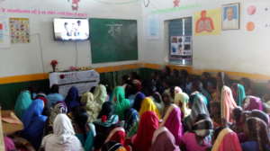 Women watching film related to awareness on menses