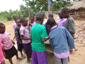 Pupils learning how to sieve sand