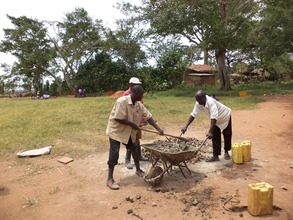 Mixing concrete in a wheel barrow for the base
