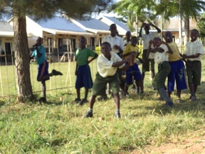 Pupils cleaning up their school compound