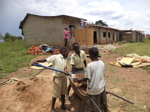 Pupils volunteering to sieve the sand