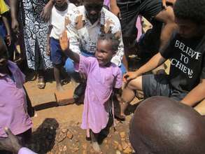 The kid waves after using the water from the tank