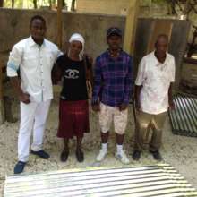Kenold and his Family Receiving Tin Roofing
