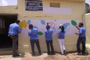 Volunteers painting a BLC center