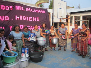 Mother volunteers with new kitchen supplies