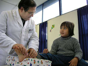 Dr Jorge Rojas treats a burned child at COANIQUEM