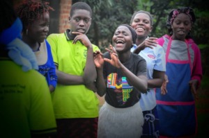 Girls sharing a light moment in Bukasa community