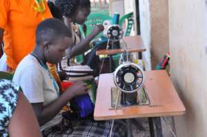Girls learn to use sewing machines to make clothes