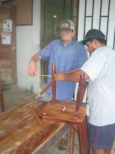 Fixing chairs - senior student and volunteer